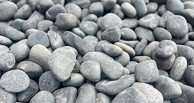 Blasted black landscape pebbles, close-up texture
